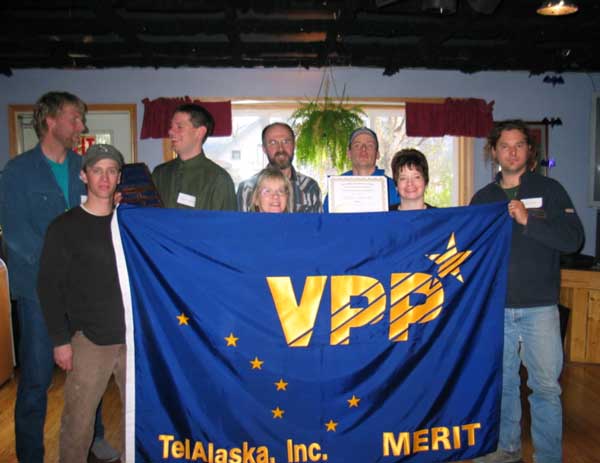 TelAlaska employee holding VPP banner